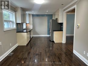 Toronto (Danforth Village-East York) apartment for rent - A kitchen with wood floors and a refrigerator.