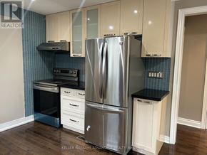 Toronto (Danforth Village-East York) apartment for rent - A kitchen with a stainless steel refrigerator, oven, and cabinets.