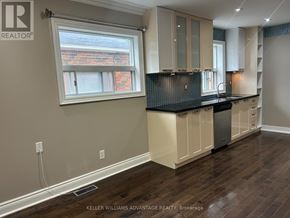 Toronto (Danforth Village-East York) apartment for rent - A kitchen with wooden floors and white cabinets.