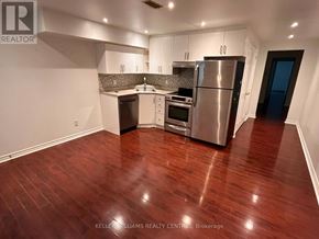 Toronto (Weston-Pellam Park) apartment for rent - A kitchen with stainless steel appliances and wooden floors.