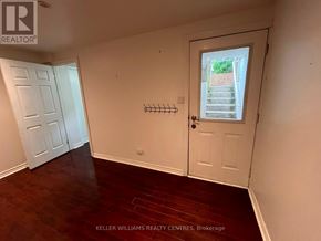 Toronto (Weston-Pellam Park) apartment for rent - A room with a door and a window with a view of a garden outside.