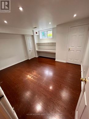 Toronto (Weston-Pellam Park) apartment for rent - A room with a wooden floor and white walls.