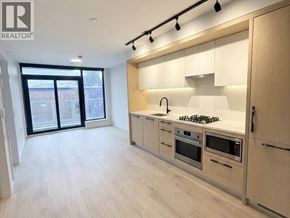 Vancouver apartment for rent - A modern kitchen with wooden cabinets and stainless steel appliances.