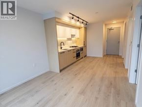 Vancouver apartment for rent - A spacious kitchen with wooden floors and a modern design.