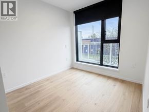 Vancouver apartment for rent - A room with a large window and wooden flooring.
