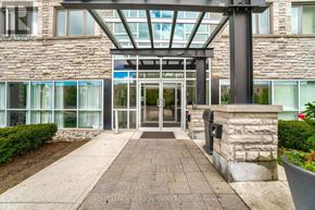 Mississauga (Mississauga Valleys) condo for rent - The entrance to a building with a glass door and a stone pillar.