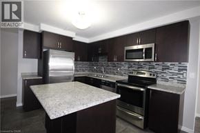 Kitchener townhouse for rent - A kitchen with a granite countertop and stainless steel appliances.