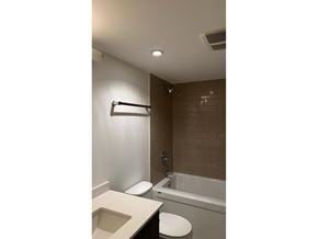 Surrey apartment for rent - A bathroom with a toilet, sink, and bathtub.