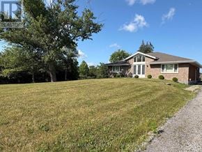 Niagara Falls (Schisler) apartment for rent - A house with a gravel path leading to the front door.