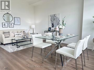 Toronto (Yonge-St. Clair) condo for rent - A modern dining room with a glass table and white chairs.