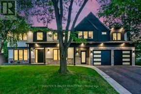 Oakville (Fd Ford) apartment for rent - A house with a dark front yard and a tree in front of it.
