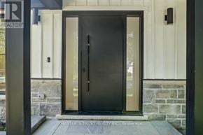 Oakville (Fd Ford) apartment for rent - A black door with a glass window is the main focus of the image.