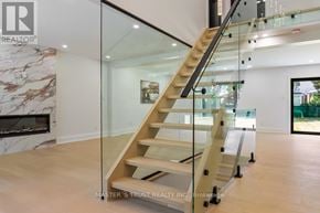 Oakville (Fd Ford) apartment for rent - A glass staircase with a wooden handrail and steps.