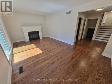 Markham (Bayview Fairway-Bayview Country Club Esta apartment for rent - A spacious room with wooden flooring and a fireplace.