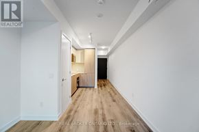 Toronto (Moss Park) condo for rent - A long hallway with a door at the end.