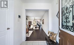 Brampton (Northwest Brampton) apartment for rent - A hallway with a bench and a door leading to a living room.
