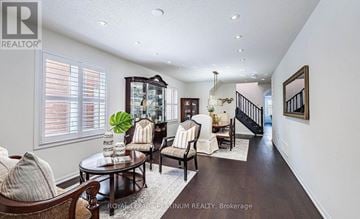 Brampton (Northwest Brampton) apartment for rent - A well-lit living room with a wooden coffee table and a staircase in the background.