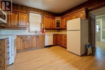 Ottawa apartment for rent - A kitchen with wooden cabinets and a white refrigerator.