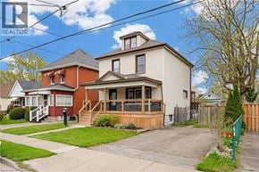 Welland apartment for rent - A house with a red roof and a white house in the background.