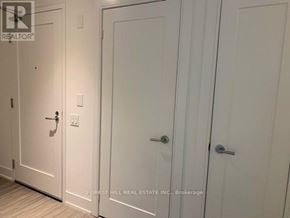 Toronto (Forest Hill South) house for rent - A hallway with three white doors and a brokerage sign.