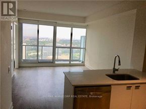 Toronto (Mount Pleasant West) condo for rent - A kitchen with a sink and a window overlooking a cityscape.