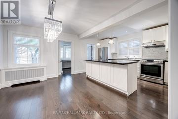 Toronto (Lawrence Park North) apartment for rent - A spacious kitchen with white cabinets and a wooden floor.