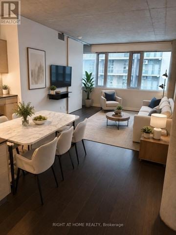 Toronto (Niagara) condo for rent - A modern living room with a dining table and chairs.