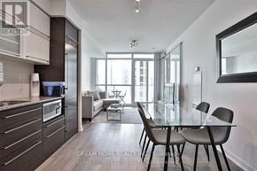 Toronto (Bay Street Corridor) condo for rent - A modern kitchen with a glass table and chairs.