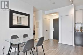Toronto (Bay Street Corridor) condo for rent - A dining room with a glass table and grey chairs.
