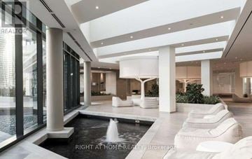 Toronto (Waterfront Communities) condo for rent - A modern living room with a pool table and a fountain.