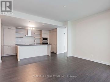 Toronto (Mount Pleasant West) condo for rent - A spacious kitchen with white cabinets and a wooden floor.