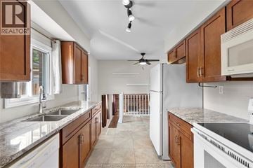 Windsor apartment for rent - A kitchen with brown cabinets and a white refrigerator.
