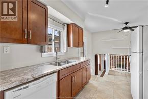 Windsor apartment for rent - A kitchen with wooden cabinets and a white dishwasher.
