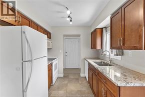 Windsor apartment for rent - A kitchen with a white refrigerator and brown cabinets.