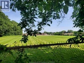Windsor apartment for rent - A green field with a fence in front of it.