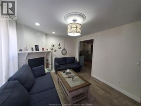 Windsor apartment for rent - A living room with a dark blue couch and a wooden coffee table.