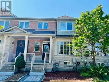 Richmond Hill (Langstaff) townhouse for rent - A house with a red door and a tree in front.