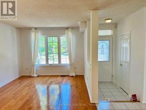 Richmond Hill (Langstaff) townhouse for rent - A room with wooden floors and white walls, with a window and a door visible.