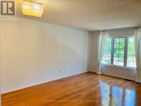 Richmond Hill (Langstaff) townhouse for rent - A room with a window and wooden floors.