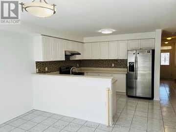 Richmond Hill (Langstaff) townhouse for rent - A kitchen with white cabinets and a tile floor.