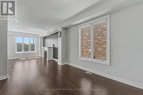 Barrie (Painswick South) apartment for rent - A large, empty room with a window and a clock on the wall.