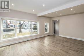 Hamilton (Landsdale) apartment for rent - A spacious room with wooden flooring and large windows overlooking a street.
