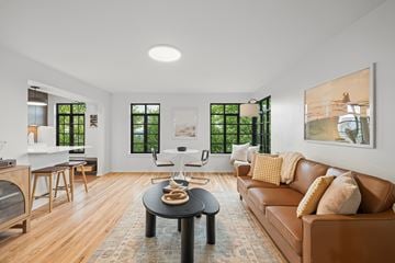 Seattle apartment for rent - A living room with a brown leather couch and a black coffee table.