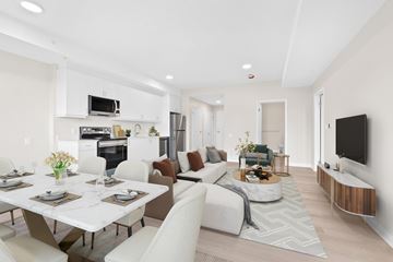 Napanee apartment for rent - A modern living room with a dining table set for four.