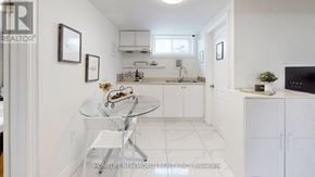 Markham (Thornhill) apartment for rent - A white kitchen with a glass table and chairs.