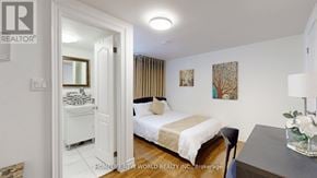 Markham (Thornhill) apartment for rent - A bedroom with a bed, a chair, and a painting on the wall.