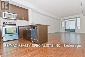 Mississauga (Port Credit) condo for rent - A kitchen with wooden cabinets and a stainless steel oven.