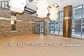 Mississauga (Port Credit) condo for rent - A lobby area with a stone wall and a large wooden column.