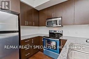 Mississauga (Port Credit) condo for rent - A kitchen with brown cabinets and a stove top oven.