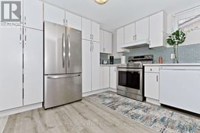 Mississauga (Applewood) apartment for rent - A kitchen with white cabinets and a stainless steel refrigerator.